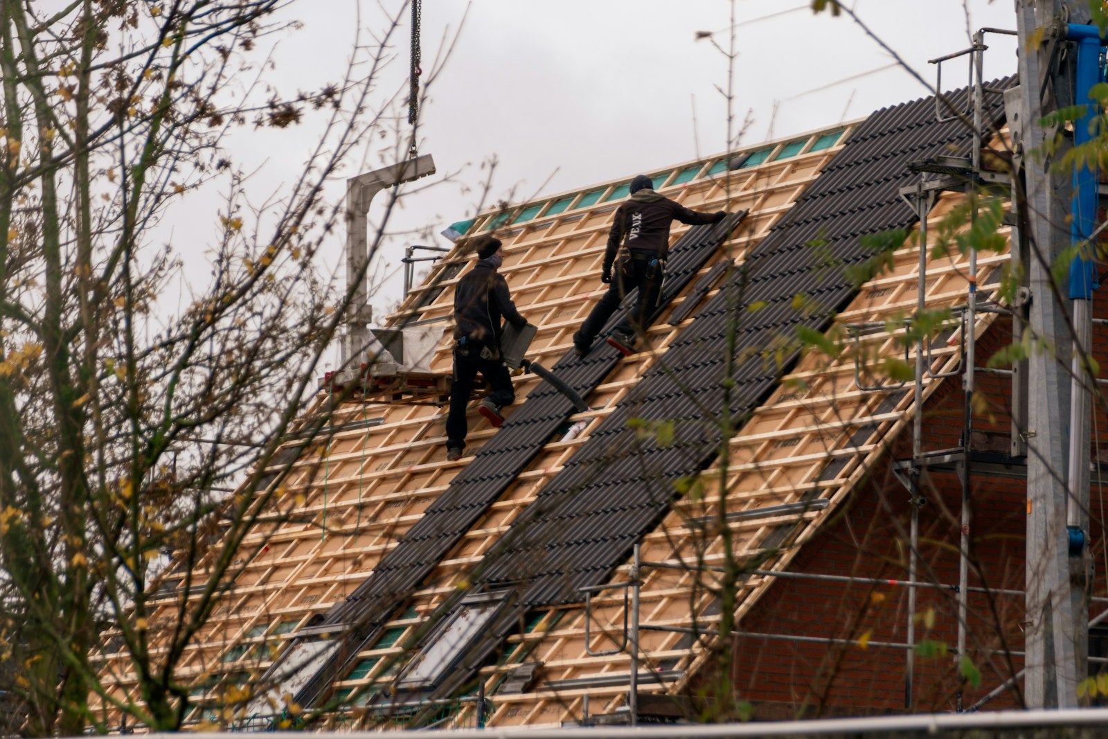Ervaren dakdekker aan het werk op een dak